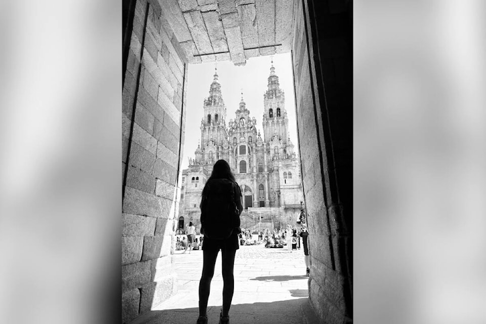 Nikki Anderson stands in silhouette in front of the cathedral of Santiago de Compostela in Galicia, Spain after completing the 280-kilometre-long Camino Portuguese, part of the Camino de Santiago. (Photo contributed) 