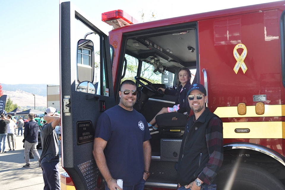 Nataija LeCaine takes the driver’s seat in a 鶹ѡ firetruck at the August Luxury Motorcars charity car show on Oct. 1, 2023. (Brittany Webster/Capital News) 