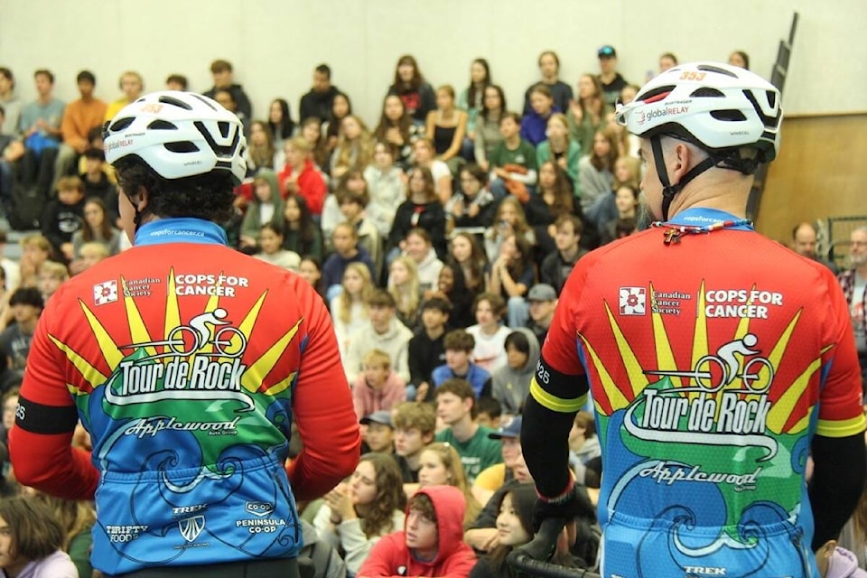 The 2023 Tour de Rock team stops for a celebratory announcement of the Oak Bay High fundraising total on Thursday (Oct. 5). (Christine van Reeuwyk/News Staff) 