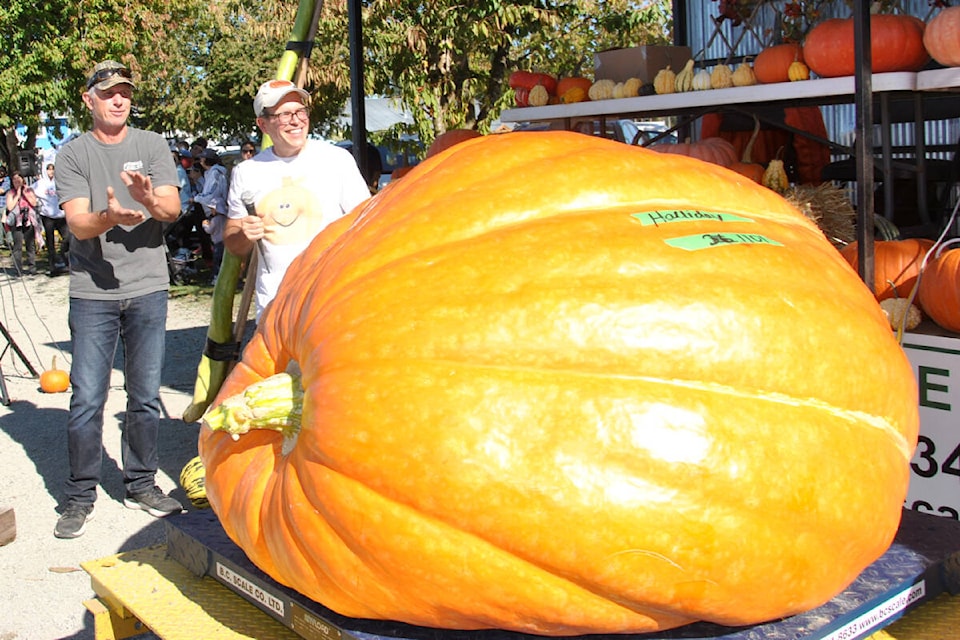 Trevor Halliday of Maple Ridge came in second at the Giant Pumpkin B.C. contest at Krause Berry Farms Saturday, Oct. 7. He applauded as the actual weight of 1,052 came up on the scale. It was a little lighter than he estimated, expecting it would come in closer to 1,101. (Roxanne Hooper/Black Press Media) 