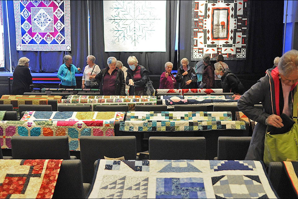 People take in the Chilliwack Quilters’ Guild’s biannual show ‘Sew’d to Joy’ at Chilliwack Alliance Church on Saturday, Oct. 14, 2023. (Jenna Hauck/ Chilliwack Progress) 