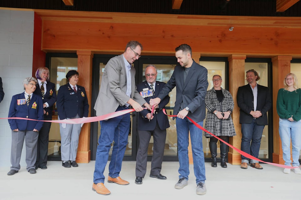 Langford Mayor Scott Goodmanson, Royal Canadian Legion Branch 91 president Norm Scott and Justin de Goesbriand, project manager with Sawyer Construction, cut the ribbon officially reopening the branch after extensive renovations. (Justin Samanski-Langille/News Staff) 