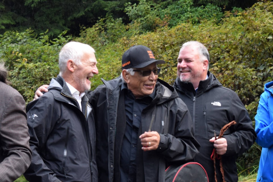 Former Huu-ay-aht elected Chief Councillor Robert Dennis Sr. (centre) celebrates the official Bamfield Road opening on Tuesday, Oct. 10 with former MLA Scott Fraser and current MP Gord Johns. (ELENA RARDON / Alberni Valley News) 