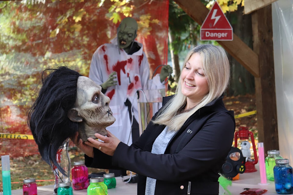 Angella Campos putting the finishing touches on her ‘Terror on Tiswilde’ display. (Photo by Tim Collins) 