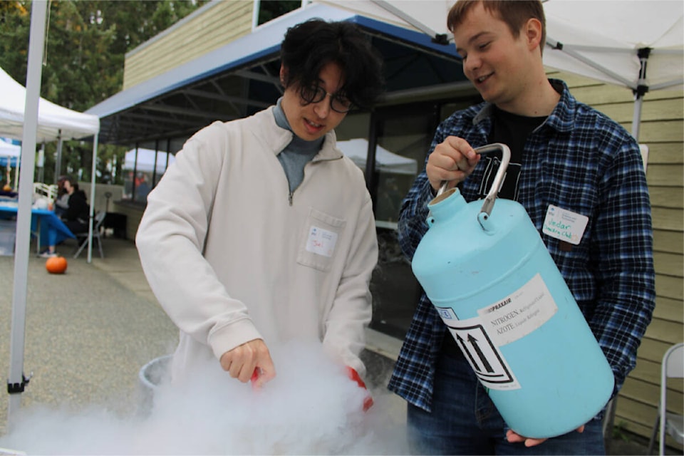 Joel Coleman, left, and Jindar Sboto, respective director and co-president of VIU’s Chemistry Club make ice cream with help from a reaction with liquid nitrogen. (Karl Yu/News Bulletin) 