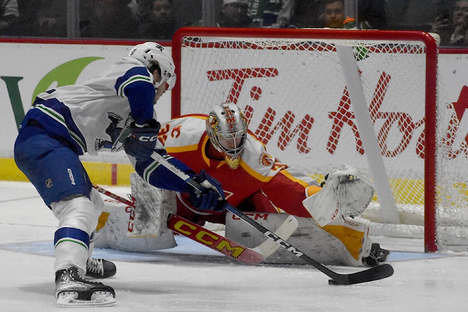 Abbotsford Canucks forward Josh Bloom attempts to deke out Calgary Wranglers goalie Dustin Wolf on a breakaway on Friday (Oct. 20). (Ben Lypka/Abbotsford News) 