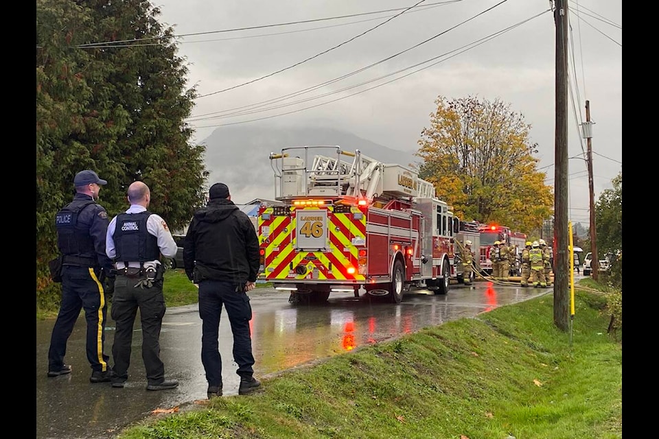 Multiple fire trucks and emergency response vehicles arrived on Sumas Road to battle a fire that broke out on the afternoon of Oct. 24. Billowing smoke filled the air as firefighters works together to keep it under control. (Chadd Cawson/Citizen) 