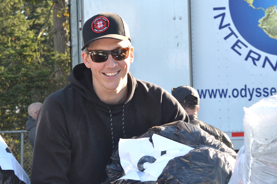  Firefighters of the 91ԭ Township collected clothing donations from local schools and loaded them into a trailer brought in from Odyssey International on Friday, Oct. 27. (Kyler Emerson/91ԭ Advance Times)  