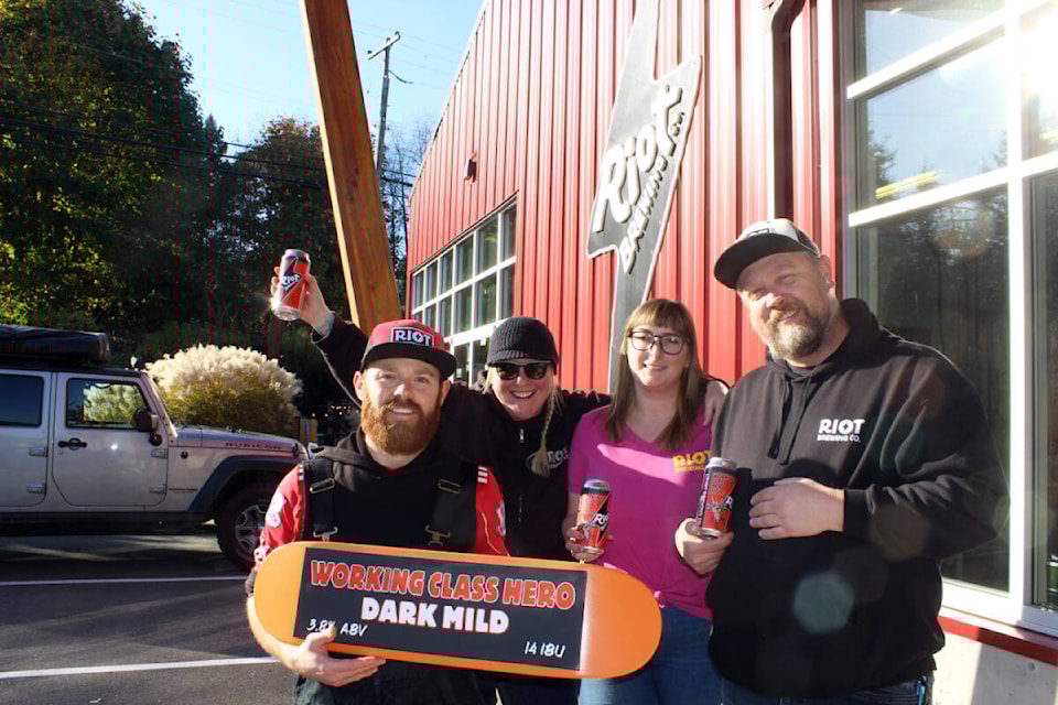 And they’ll have fun, fun, fun in the sun, sun, sun at Riot Brewing. From left: Brewer Jesse Grass, co-owner Aly Tomlin, manager Shay Kuhnert and co-owner Ralf Rosenke are in a celebratory mood from a bronze award for its Working Class Hero dark mild at the Canada Beer Cup. (Photo by Don Bodger) 