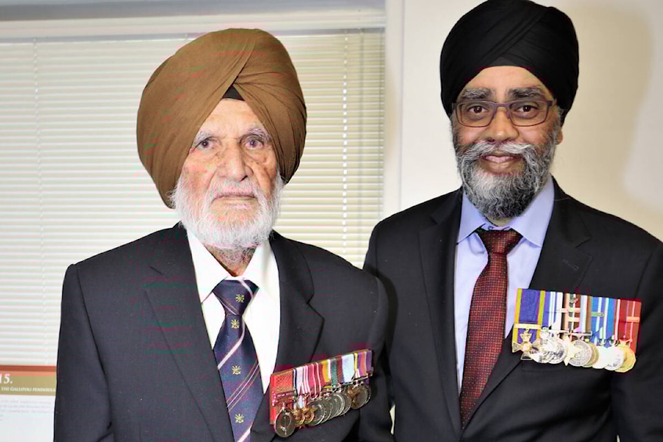 Second World War soldier Major Naib Singh Grewal stands with Harjit Singh Sajjan, the then Minister of National Defence, at the Ross Street Temple in Vancouver in 2019. Both were there for book release of “Duty, Honour, and Izzat.” The graphic novel, written by historian Steven Purewal, tells the story of an important battle from WWII. (Photo submitted: Steven Purewal) 