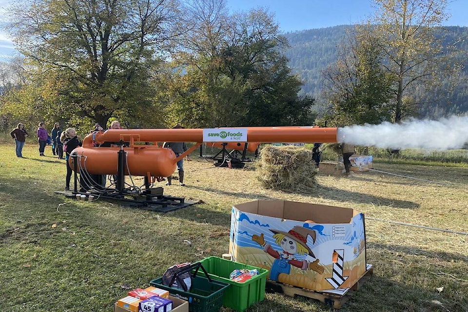Qualified crews make pumpkin puree with the pumpkin canon, which was a blast, at Mara’s Riverside Ranch food bank fundraiser Saturday afternoon. (Heather Black-Eagle Valley News) 