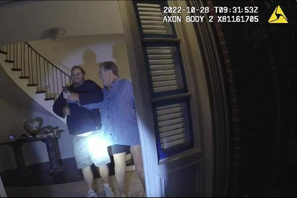FILE - In this image taken from San Francisco Police Department body-camera video, the husband of former U.S. House Speaker Nancy Pelosi, Paul Pelosi, right, fights for control of a hammer with his assailant David DePape during a brutal attack in the couple’s San Francisco home on Oct. 28, 2022. Opening statements are scheduled for Thursday, Nov. 8, 2023, in the federal trial of the man accused of breaking into former House Speaker Nancy Pelosi’s San Francisco home seeking to kidnap her and bludgeoning her husband with a hammer. (San Francisco Police Department via AP, File) 