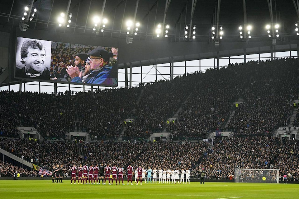 Players and fans applaud during a tribute to former England player and coach Terry Venables,shown on the video screen, before the English Premier League soccer match between Tottenham Hotspur and Aston Villa at the Tottenham Hotspur stadium in London, Sunday, Nov. 26, 2023. Venables has passed away, it was announced Sunday. (AP Photo/Kirsty Wigglesworth) 