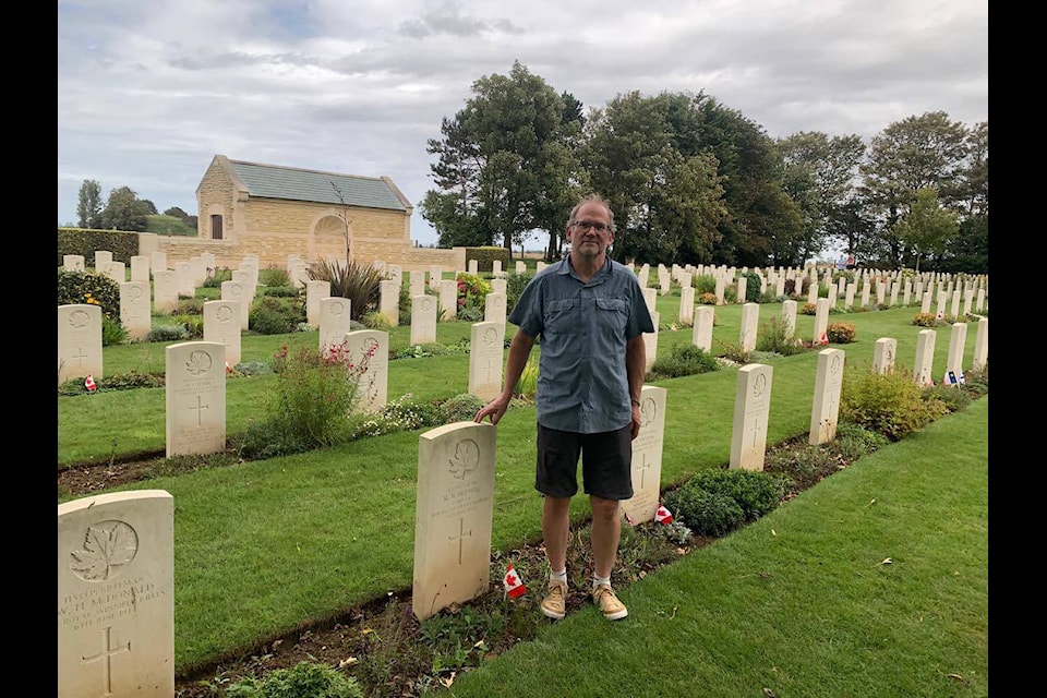 Deryk Yuill stands beside his uncle Ronald Brewer’s grave in Graye-sur-Mer Cemetery in France. He and his family uncovered the history behind his uncle’s wartime service at Juno Beach while on a sailing trip off the coast of Northwest Europe (Photo courtesy of Yuill family) 