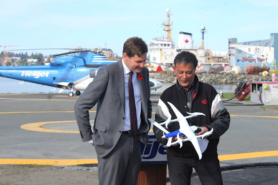 HeliJet CEO Danny Sitnam (right) shows Premier David Eby a model of an electric aircraft HeliJet has ordered, which is expected to be the first of its kind in Canada, during an event in Victoria on Oct. 31. (Jake Romphf/News Staff) 