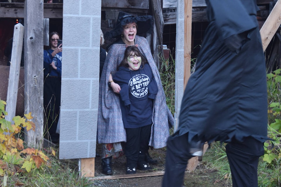 Visitors react to a spooky character at the end of the maze during The Haunting at McLean Mill. The Haunting was a fundraiser for ADAPS family services. (ELENA RARDON / Alberni Valley News) 