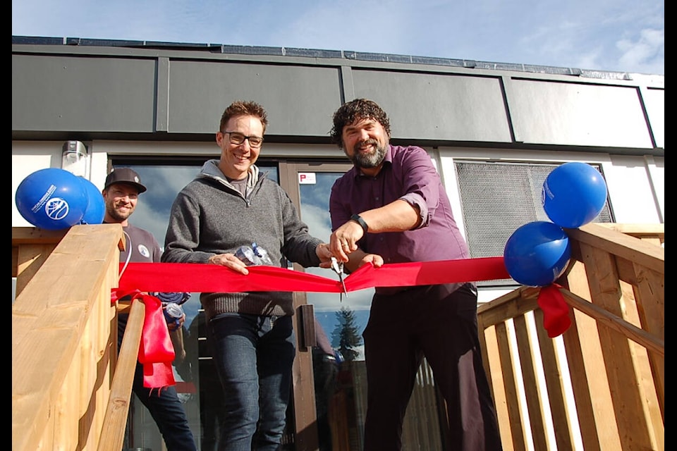 Duncan Christian School principal Peter Terpstra cuts the ribbon on the school’s new portable with Colin Mullet and board member Reed Gary. (Photo courtesy of DCS) 