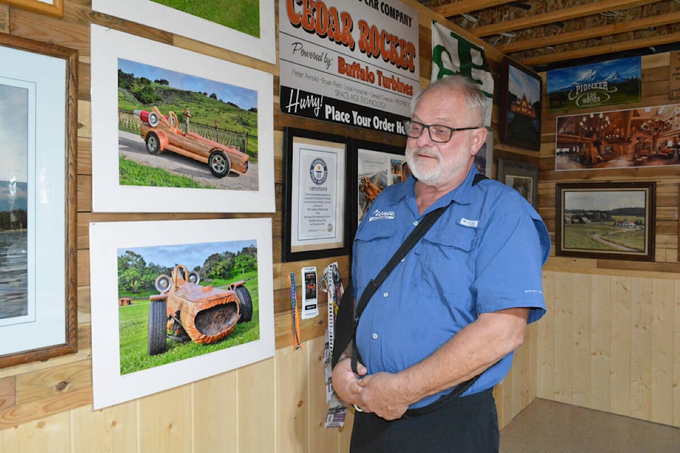 Pioneer Log Homes of B.C. founder Bryan Reid Sr. smiles as he talks about the Cedar Rocket, a log car he and his long-time friend Gerald Overton created. (Monica Lamb-Yorski photo - Williams Lake Tribune) 