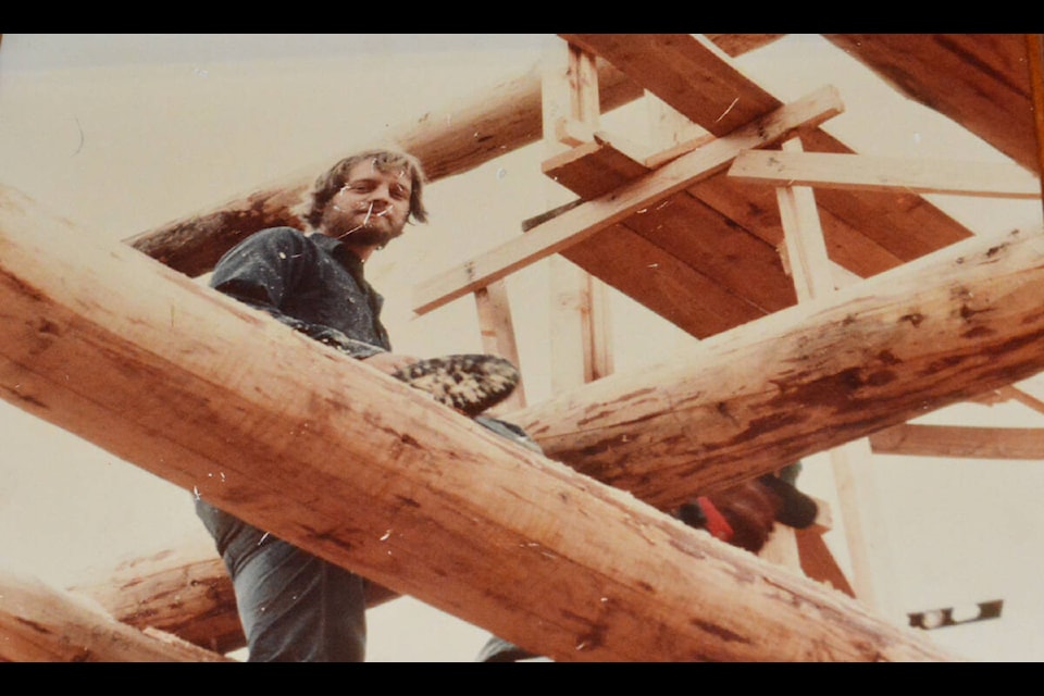 A young Bryan Reid Sr. building a Pioneer log home. (Photo submitted) 
