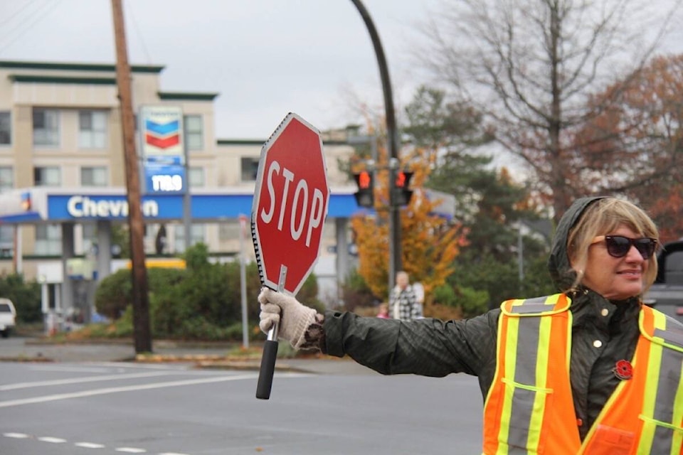 Longtime education assistant Caroline Thompson serves as crossing guard twice a day at the intersection of Cook and Quadra streets in Saanich. Her goal is to get students, and the general public, across the road safely in a sometimes hostile environment. (Christine van Reeuwyk/News Staff) 