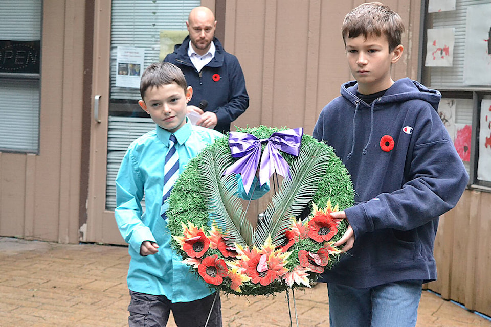 Paxton Pires, left, and Nate Funk, both 11, laid the wreath on behalf of the children of Whonnock by a Remembrance plaque during the Whonnock Lake Remembrance Day ceremony. (Colleen Flanagan/The News) 