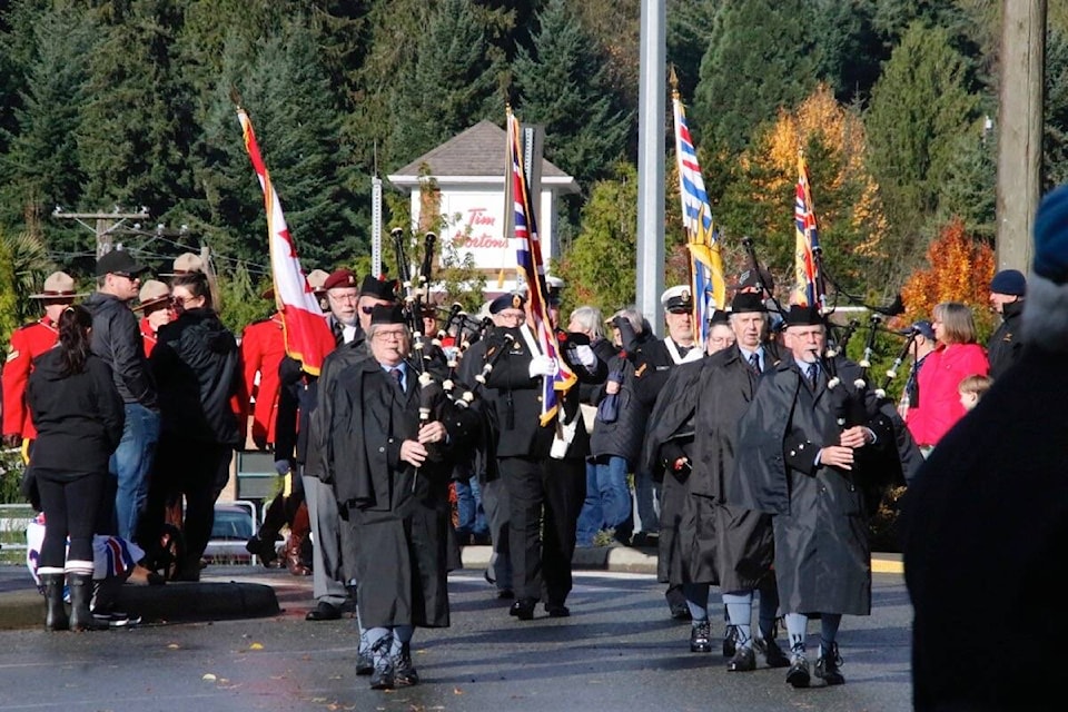 Led by Cowichan Pipes and Drums, the parade marches to the cenotaph in Lake Cowichan on Remembrance Day, Nov. 11, 2023. (Lexi Bainas photo) 