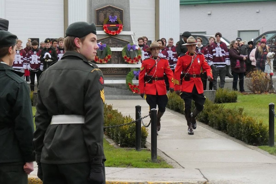 RCMP officers place wreaths on the cenotaph in Revelstoke. (Connor Arsenault) 