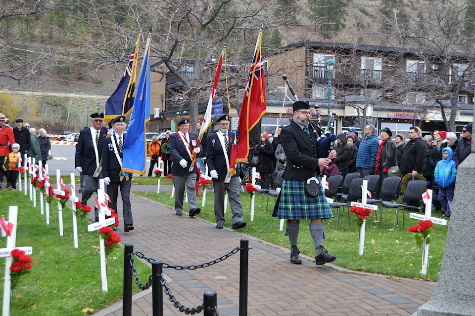 A Colour Party from Royal Canadian Legion 69 is escorted by a bagpiper to the Peachland Cenotaph during Remembrance ceremonies on Nov. 11, 2023. (Gary Barnes Capital News) 