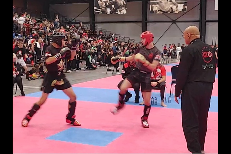 Josh Sutherland, on left, fights his opponent at the WKU World Championships in Calgary in October. He placed second at the kickboxing competition (Courtesy of Kathryn Casimer) 