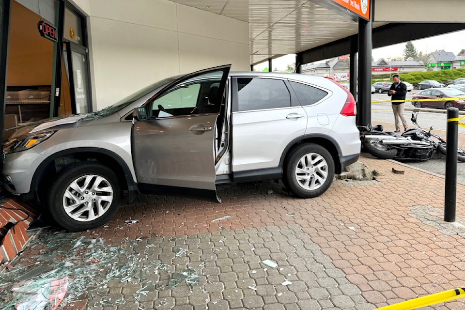  The driver of a silver Honda CR-V drove over a parked motorcycle and bollard before crashing into the store front of Bubble World in Walnut Grove early Tuesday afternoon, Nov. 21. (Lois Phillips/Special to Langley Advance Times) 