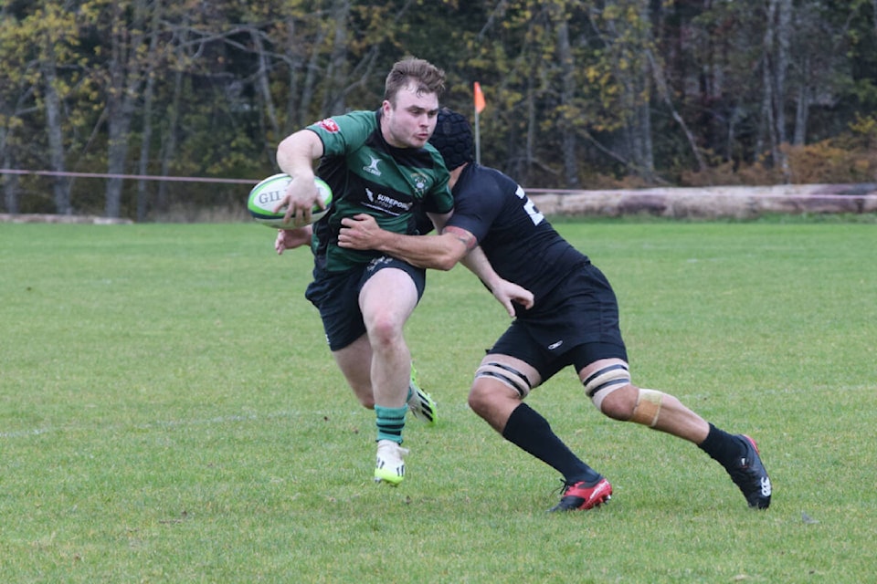 A Cowichan Piggies player manages to escape the tackle of Port Alberni’s Ryan Turner during BC Rugby action on Saturday, Nov. 18. (ELENA RARDON / Alberni Valley News) 