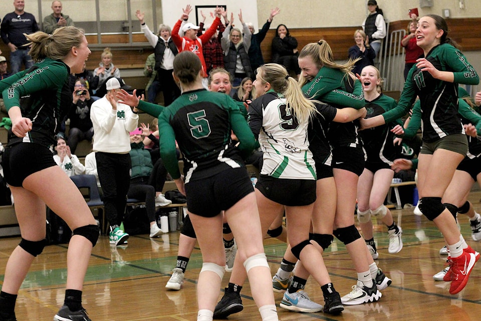 NDSS Islanders players celebrate match point as they defeat the Mt. Douglas Rams in five sets to win the Vancouver Island senior AAAA girls’ volleyball championship Saturday, Nov. 18, at the Dover Bay Secondary School gym. (Greg Sakaki/News Bulletin) 