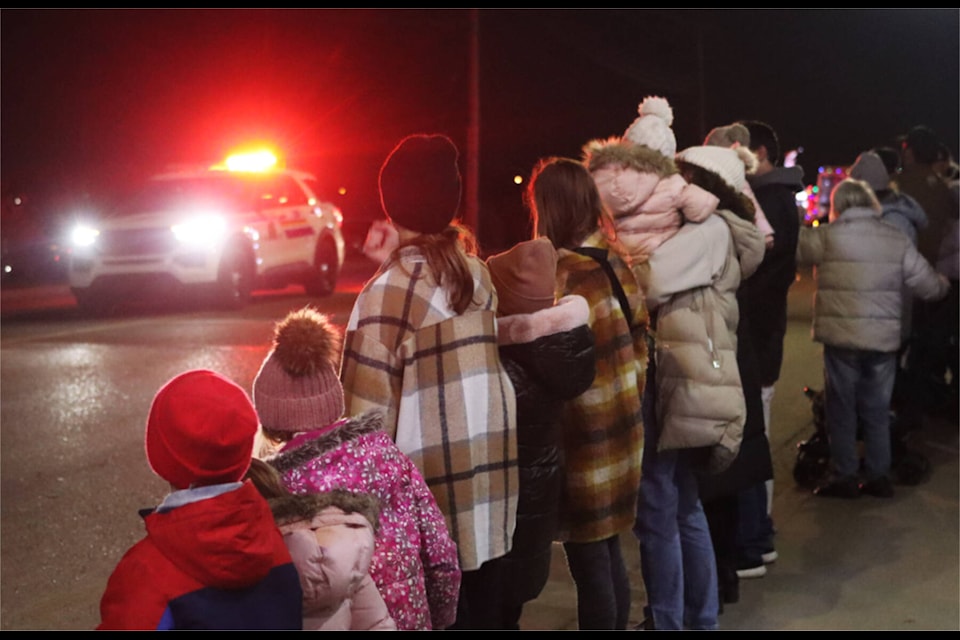 Excited kids watch the floats pass down 50 Street during the Santa Claus Parade Nov. 17, snatching up candy as the vehicles pass. (Photos by Emily Jaycox/Ponoka News) 