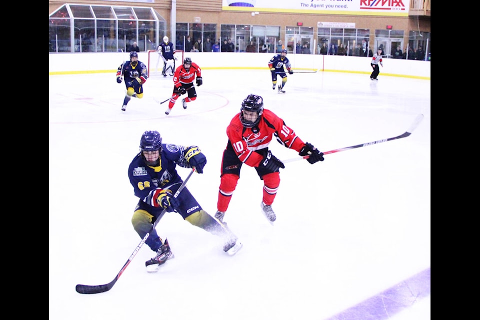 100 Mile House Wrangler Jack Mulder sids to a halt to foul up a Chase Heat player. (Patrick Davies photo - 100 Mile Free Press) 