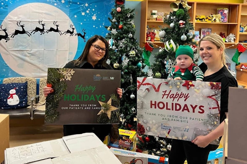 Floor Envy’s Lacey Kelly, left, with Lucas and Mom Ashley Irvine. Irvine and her husband started the toy drive in honour of their son Blake, who died in 2020. (Contributed photo) 