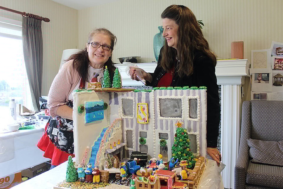 Margie Edwards (left), director of administrative services at Parkwood Place and Cheryl Chalifour (right), executive director have spent hundreds of combined volunteer hours creating their entry for Habitat for Humanity’s Gingerbread Showcase. (Samantha Duerksen/Black Press Media) 