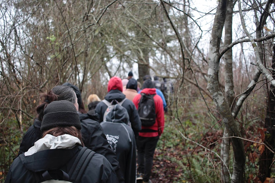 Robron students follow Greenways Land Trust, We Wai Kai Guardians and We Wai Kum Guardian Watchmen staff through the forest near where Nunns Creek meets the Campbell River estuary. Photo by Marc Kitteringham/Campbell River Mirror 