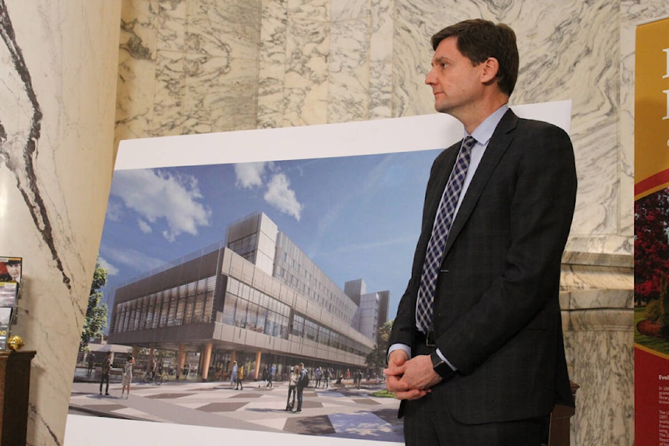 Premier David Eby stands beside the new UVic residence that has provided hundreds of students with housing since it opened in September. (Ella Matte/News Staff) 