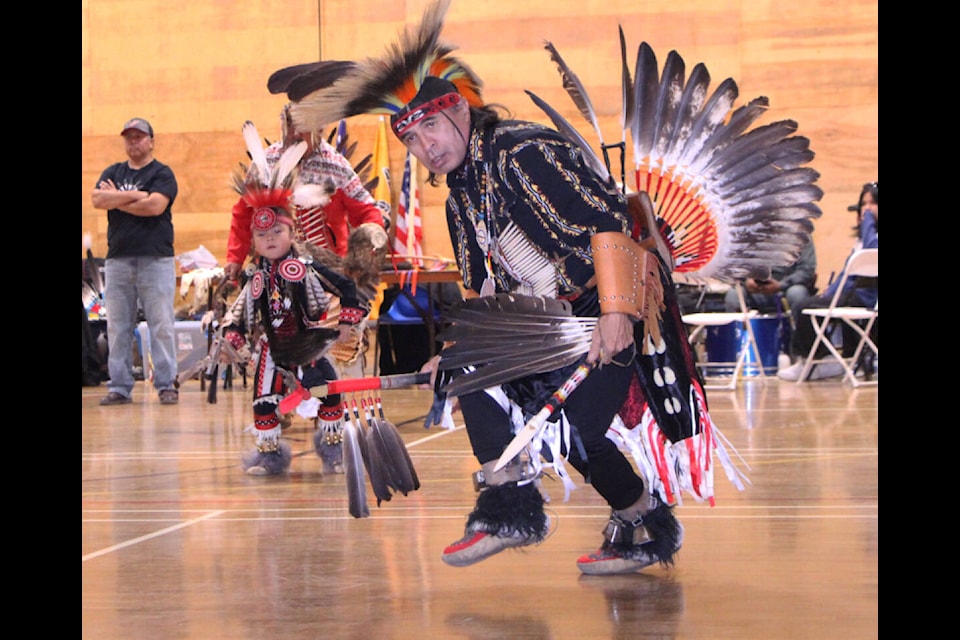 Bill Mansell leads Shay Edgar in a traditional men’s dance during the Tsq<strong>̓</strong>éscen<strong>̓</strong> First Nation’s inaugural Strength Through Our Ancestors Pow-wow on Saturday, Nov. 25. (Patrick Davies photo - simplymastery) 