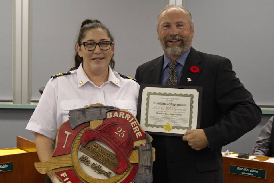 Fire Chief Ashley Wohlgemuth (l) and Barriere Mayor Ward Stamer during the Nov. 6, 2023 council meeting, where the chief was presented with an award from the district commemorating her 25 years of volunteer service with the Barriere Fire Department. (District of Barriere)