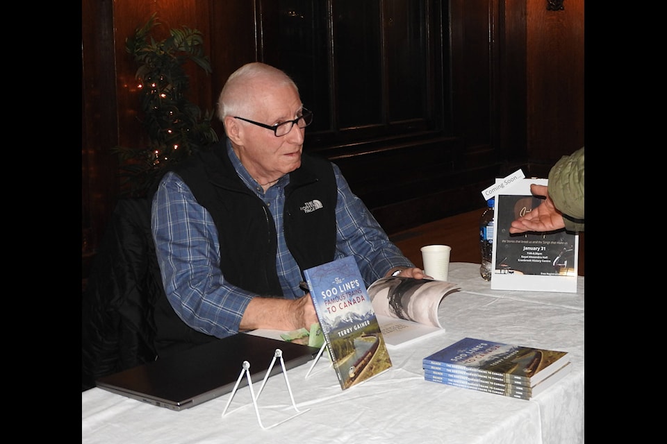 Terry Gainer signs copies of his latest book, “The Soo Lines Famous Trains to Canada,” at the Cranbrook History Centre on Nov. 22. The book covers the history of famous tourist trains that carried sightseers to the Rockies (Photo by Gillian Francis) 