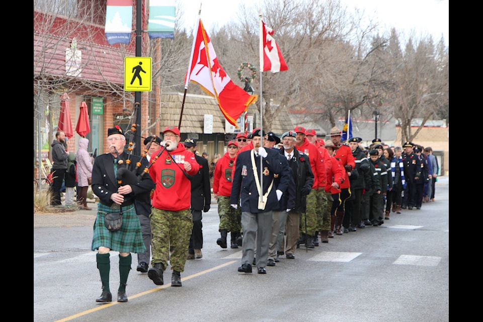 Members of 100 Mile House’s Legion, Canadian Ranger Patrol, RCMP, Cadet Corp, Girl Guide Troop and the 100 Mile House Wranglers hockey team all marched down Birch Avenue to commemorate Remembrance Day. (Patrick Davies photo - simplymastery) 