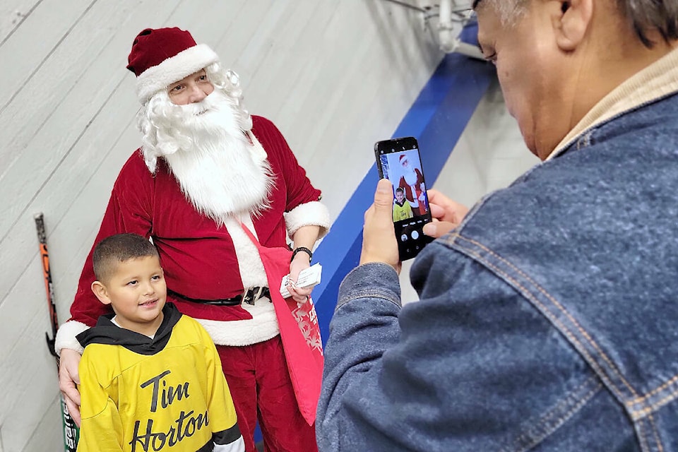 North 91ԭ resident Ryder, 7 had his picture taken with Santa by grandfather Louchie Harry, who was visiting from Powell River, at the 2022 Santa Skate organized by 91ԭ Minor Hockey Association at George Preston arena. This year’s event will be held Sunday, Dec. 3 at George Preston from 11:30 a.m. to 1 p.m. (91ԭ Advance Times files) 
