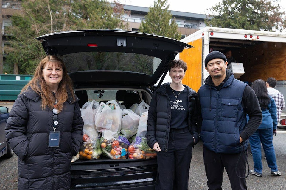Nicole Preston, left, Chloe Leslie, and Kevin Green, stand in front of Green’s weekly pick up for Vancouver Food Rescue in Surrey on Thursday, Nov. 30, 2023. (Photo: Anna Burns) 