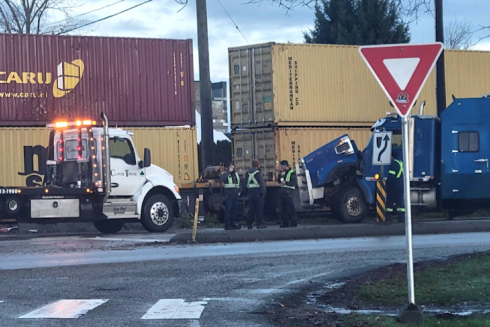  A water tank truck that was part of a construction project crashed with a train passing through along Glover Road early Saturday morning, Dec. 2. Traffic is blocked on the Langley Bypass, 216th Street, and Glover Road. (Kyler Emerson/Langley Advance Times) 