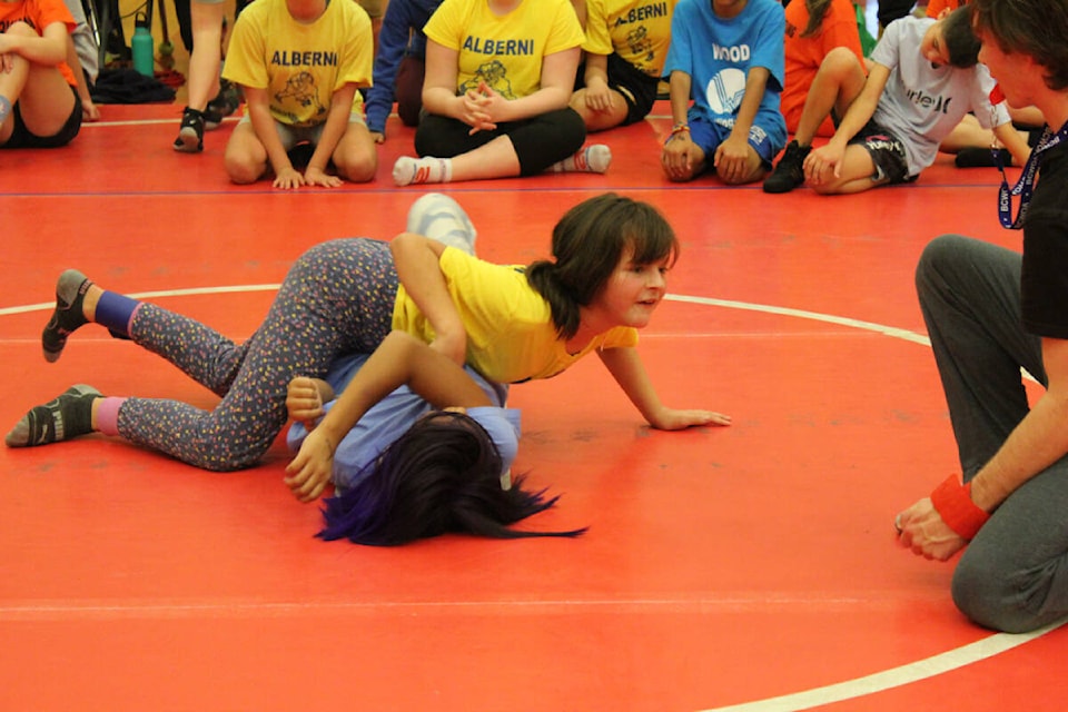 A wrestler looks to an official to see if she gets a pin during the 2023 Pacific Rim Elementary Wrestling Tournament at ADSS gymnasium on Friday, Nov. 3, 2023. (DIANA GORGES PHOTO) 