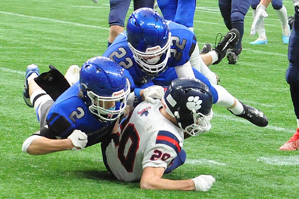 Ballenas Wallers Riley Wilson and Tyler Robinson bring down Vernon Panther runner Ayden McDonald Saturday at BC Place. (Michael Briones photo) 