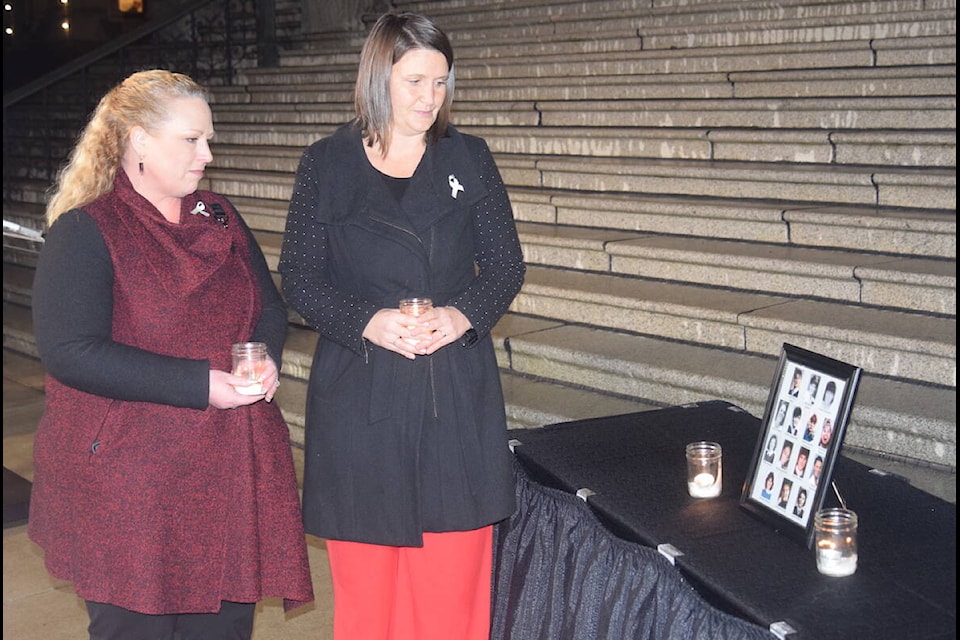 Parliamentary secretary for gender equity Kelli Paddon (left) and Victoria-Beacon Hill MLA Grace Lore (right) speak at a candlelight memorial Wednesday (Dec. 6) at the B.C. legislature. The event was held to commemorate the 14 women killed during the Montreal massacre. (Brendan Mayer/ Staff) 