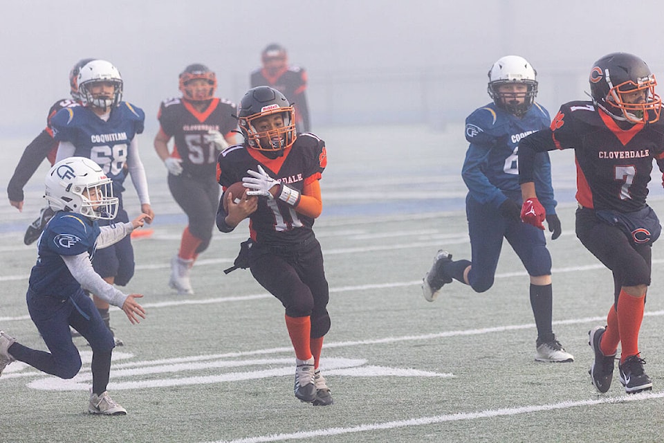 Bryson Osei (11) runs the ball against the Coquitlam Chargers in the provincial championship game at McLeod Athletic Park in Langley Nov. 26. Osei finished the game with 80 yards rushing and two touchdowns. (Photo: Jason Sveinson) 