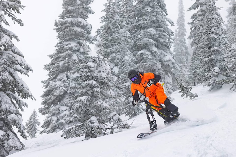 Fernie resident Ross Frazier has taken up the sport of ski biking. He can be seen on the hills in his neon orange jump suit (Photo by Vince Mo) 